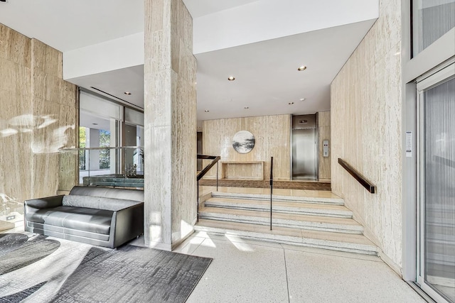 stairway featuring elevator and recessed lighting