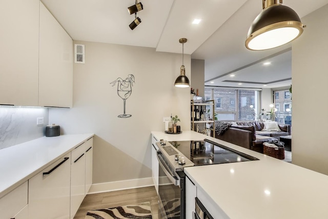 kitchen with white cabinets, light countertops, stainless steel electric range, and visible vents