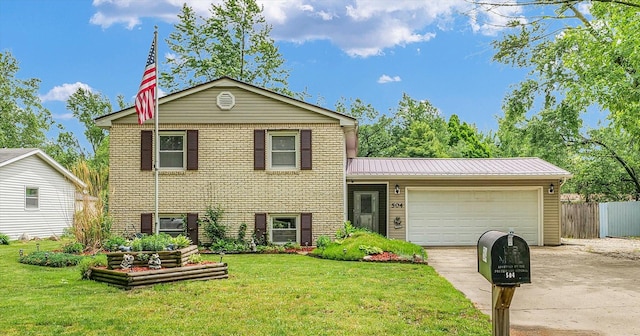 504 N 4th St, Saint Joseph, IL 61873 - tri-level home featuring driveway, a garage, brick siding, and metal roof