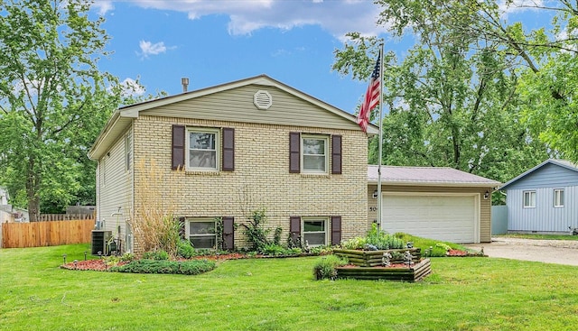 504 N 4th St, Saint Joseph, IL 61873 - tri-level home featuring driveway, a garage, central AC unit, brick siding, and metal roof