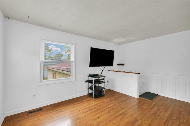504 N 4th St, Saint Joseph, IL 61873 - unfurnished living room with wood finished floors and baseboards