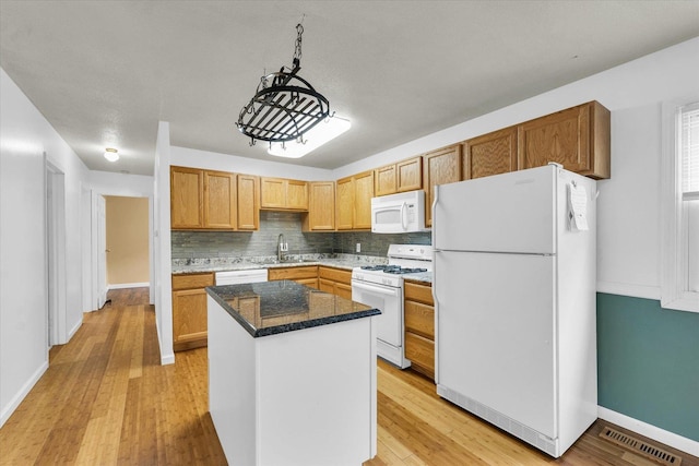 504 N 4th St, Saint Joseph, IL 61873 - kitchen with white appliances, a sink, baseboards, and light wood-style floors