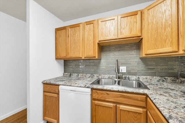 504 N 4th St, Saint Joseph, IL 61873 - kitchen featuring dishwasher, a sink, decorative backsplash, and baseboards