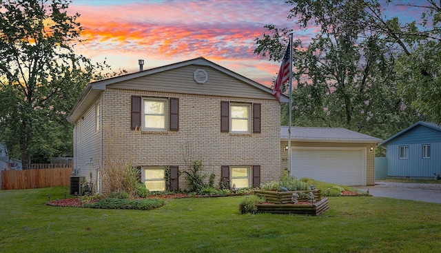 504 N 4th St, Saint Joseph, IL 61873 - tri-level home featuring driveway, cooling unit, an attached garage, and brick siding