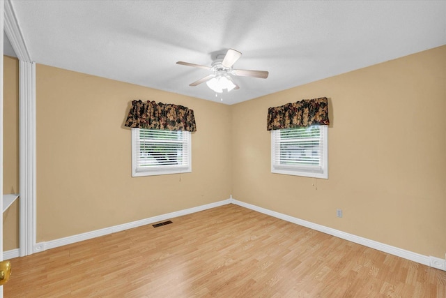 504 N 4th St, Saint Joseph, IL 61873 - unfurnished room featuring healthy amount of natural light, light wood-style flooring, baseboards, a ceiling fan, and a textured ceiling