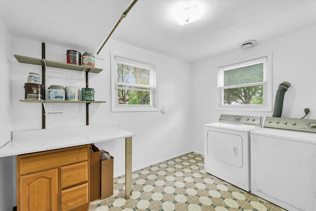 504 N 4th St, Saint Joseph, IL 61873 - laundry area featuring washing machine and dryer, baseboards, a textured ceiling, and light floors