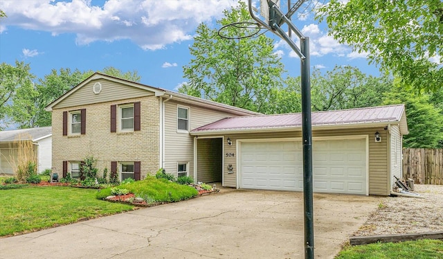 504 N 4th St, Saint Joseph, IL 61873 - split level home featuring a garage, metal roof, and driveway