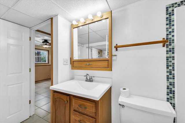 504 N 4th St, Saint Joseph, IL 61873 - bathroom with tile patterned flooring, vanity, toilet, ceiling fan, and a drop ceiling