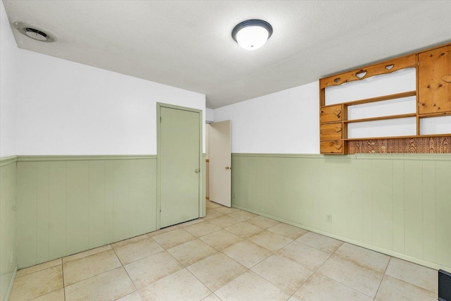 504 N 4th St, Saint Joseph, IL 61873 - empty room with wainscoting, light tile patterned floors, and wood walls
