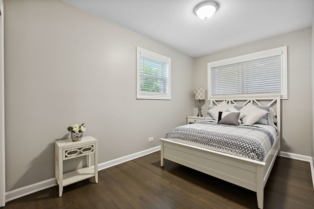 bedroom featuring dark wood-style flooring and baseboards