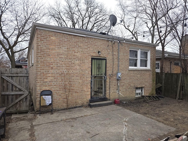 7254 S Paulina St, Chicago, IL 60636 - rear view of house with a patio, brick siding, and fence
