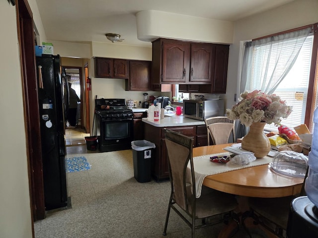 7254 S Paulina St, Chicago, IL 60636 - kitchen featuring black appliances, dark brown cabinetry, a peninsula, and light countertops