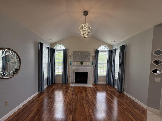 640 Schumann St, Woodstock, IL 60098 - unfurnished living room featuring wood finished floors, a chandelier, a fireplace, lofted ceiling, and baseboards