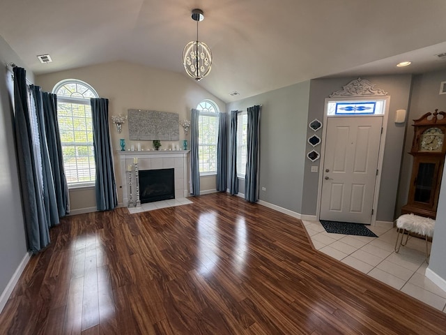 640 Schumann St, Woodstock, IL 60098 - unfurnished living room with plenty of natural light, wood finished floors, vaulted ceiling, and baseboards