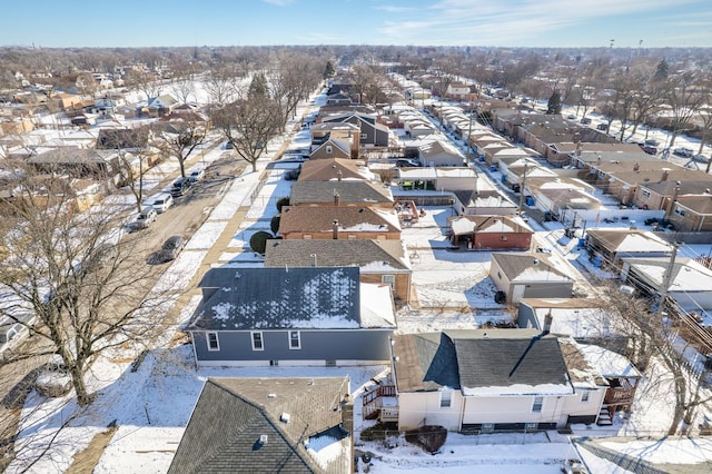 snowy aerial view with a residential view