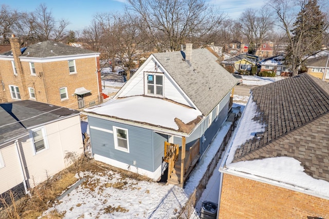 snowy aerial view with a residential view