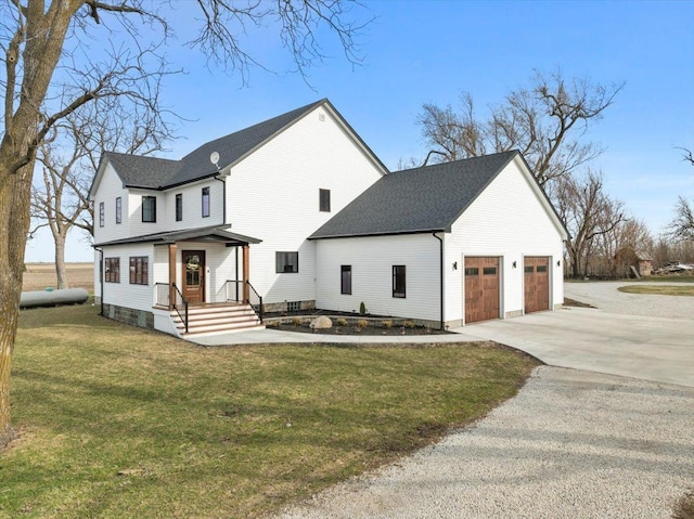 view of front facade with driveway, an attached garage, and a front lawn
