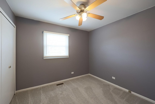 unfurnished room featuring visible vents, ceiling fan, light carpet, and baseboards