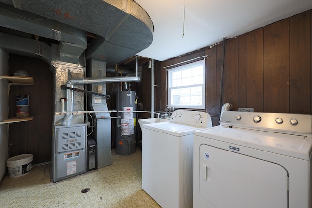 laundry area featuring washing machine and clothes dryer and gas water heater