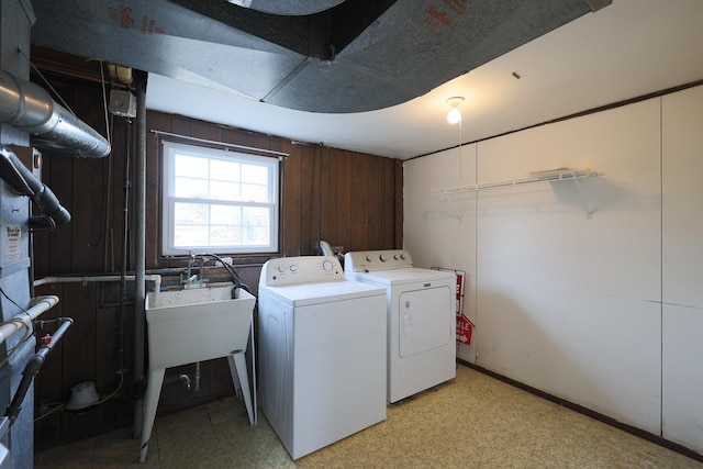 clothes washing area featuring laundry area, separate washer and dryer, and light floors