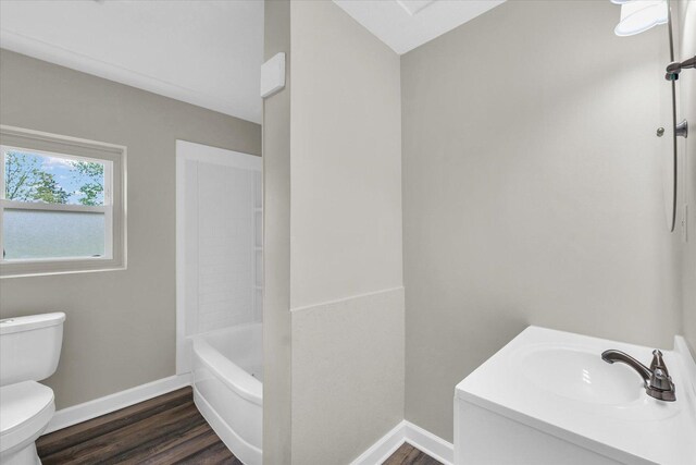 full bath with toilet, baseboards, wood finished floors, and vanity