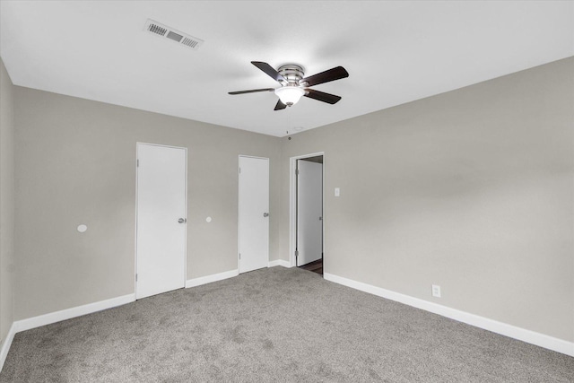 unfurnished bedroom featuring visible vents, a ceiling fan, baseboards, and carpet floors