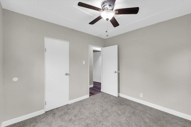 unfurnished bedroom featuring baseboards, ceiling fan, and carpet