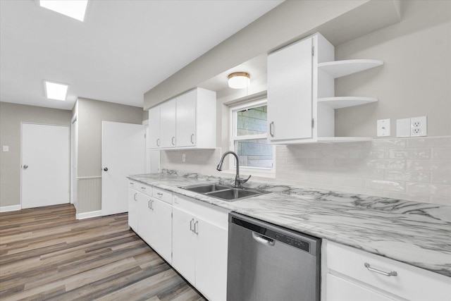 kitchen with open shelves, a sink, light wood-style floors, tasteful backsplash, and stainless steel dishwasher