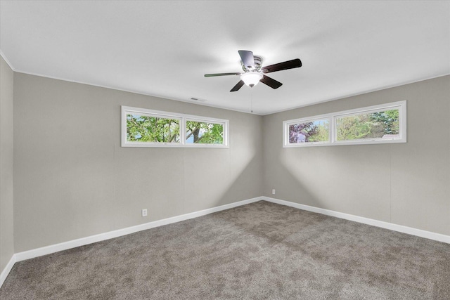 unfurnished room featuring carpet floors, a ceiling fan, baseboards, and visible vents