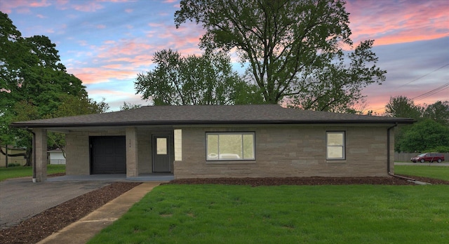view of front facade with driveway, a shingled roof, stone siding, and a front lawn