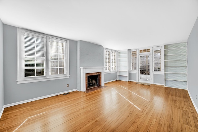 2242 Macdonald Ln, Flossmoor, IL 60422 - unfurnished living room with visible vents, a fireplace with flush hearth, built in shelves, baseboards, and hardwood / wood-style floors