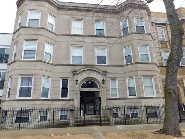view of building exterior featuring a fenced front yard