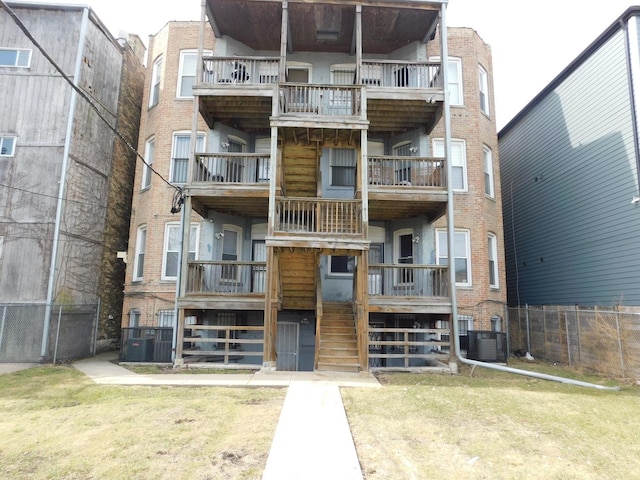 view of property featuring central AC unit and fence