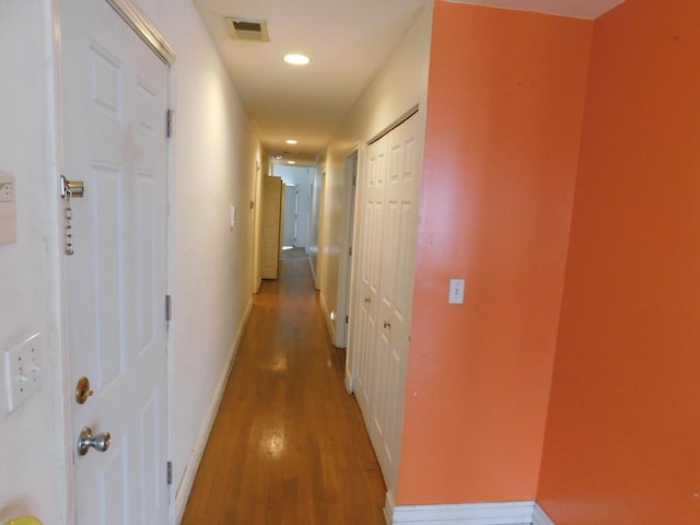 hallway with visible vents, recessed lighting, baseboards, and light wood-style floors