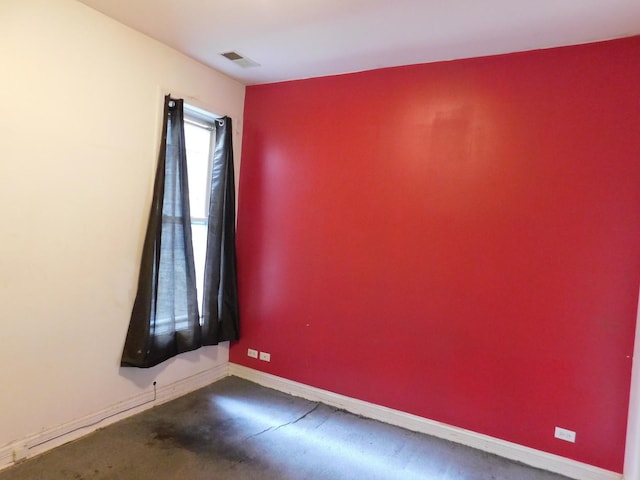 spare room with baseboards and visible vents