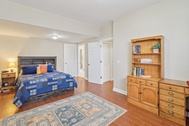 bedroom featuring baseboards and wood finish floors