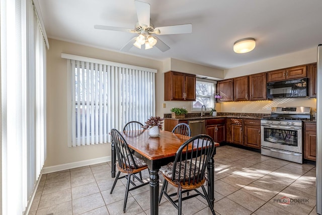 dining space with light tile patterned flooring, baseboards, and ceiling fan