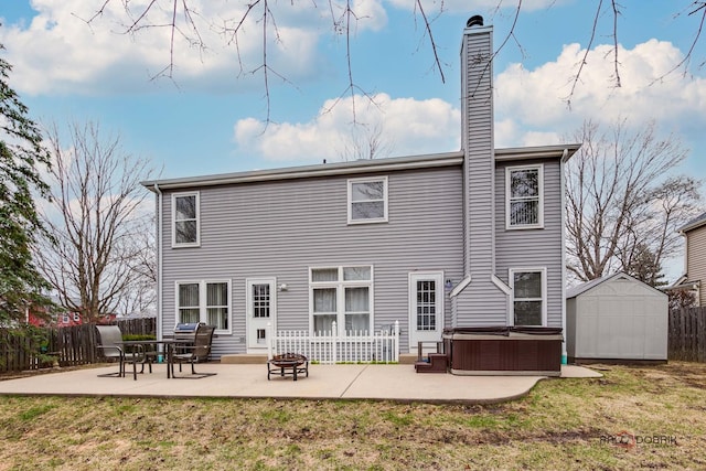 back of house with a yard, fence, a hot tub, and a patio area