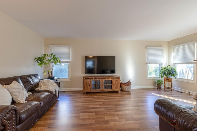 living area featuring baseboards and wood finished floors