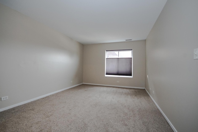 carpeted empty room with baseboards and visible vents