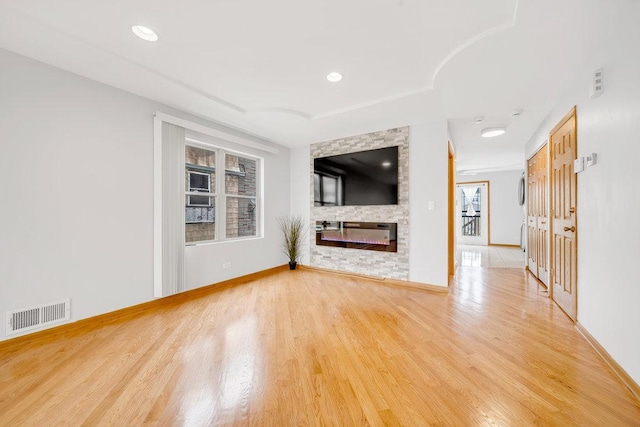 kitchen featuring freestanding refrigerator, light tile patterned flooring, a center island, a sink, and range with electric cooktop