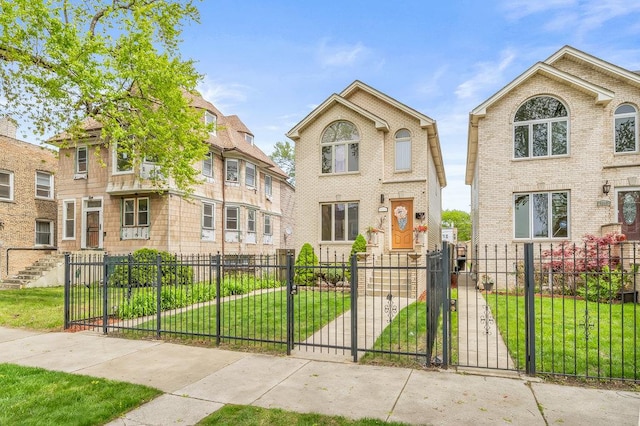 view of front of house featuring brick siding, a gate, a front lawn, and a fenced front yard