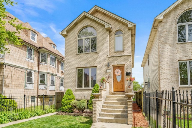 view of front of property with entry steps, fence private yard, and brick siding