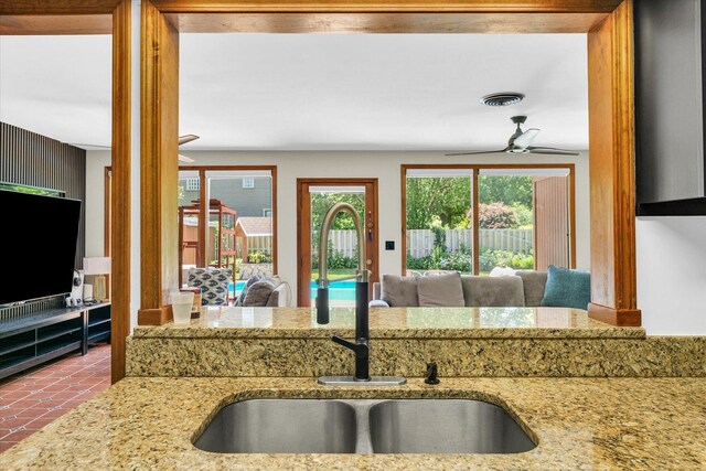 615 Haines Blvd, Champaign, IL 61820 - kitchen featuring visible vents, a sink, a ceiling fan, and light stone counters