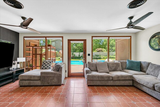 615 Haines Blvd, Champaign, IL 61820 - tiled living room with a healthy amount of sunlight, a ceiling fan, and visible vents