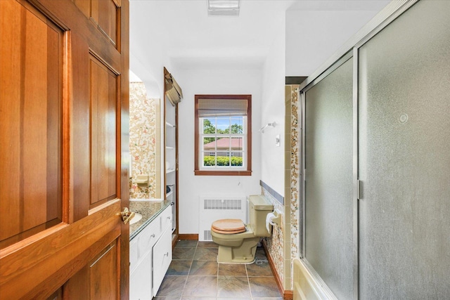 615 Haines Blvd, Champaign, IL 61820 - bathroom with a shower stall, toilet, baseboards, and radiator
