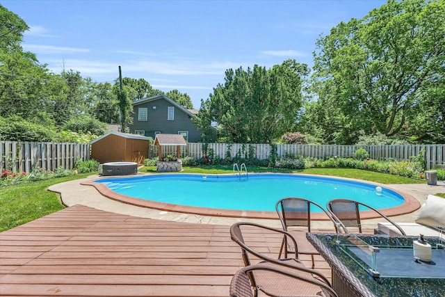 615 Haines Blvd, Champaign, IL 61820 - view of swimming pool featuring a shed, a fenced backyard, an outbuilding, a wooden deck, and a fenced in pool