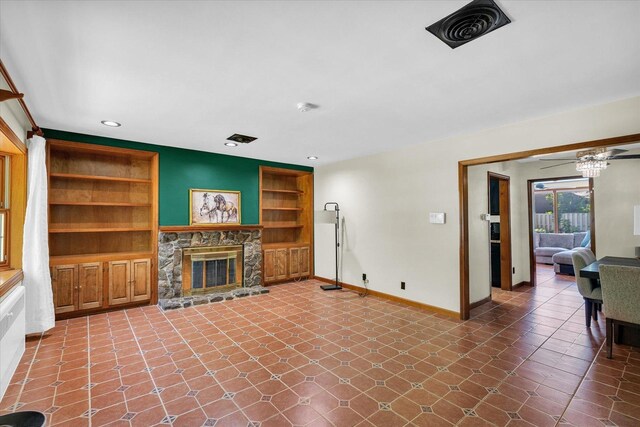 615 Haines Blvd, Champaign, IL 61820 - unfurnished living room with baseboards, a stone fireplace, built in features, visible vents, and ceiling fan