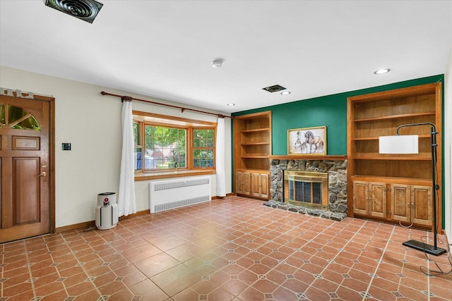 615 Haines Blvd, Champaign, IL 61820 - unfurnished living room with a stone fireplace, baseboards, recessed lighting, radiator, and built in shelves