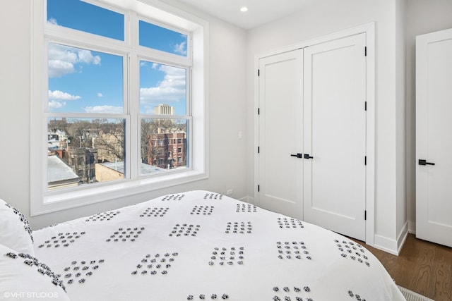1938 W Augusta Blvd Unit 504, Chicago, IL 60622 - bedroom with wood finished floors, a closet, baseboards, and recessed lighting